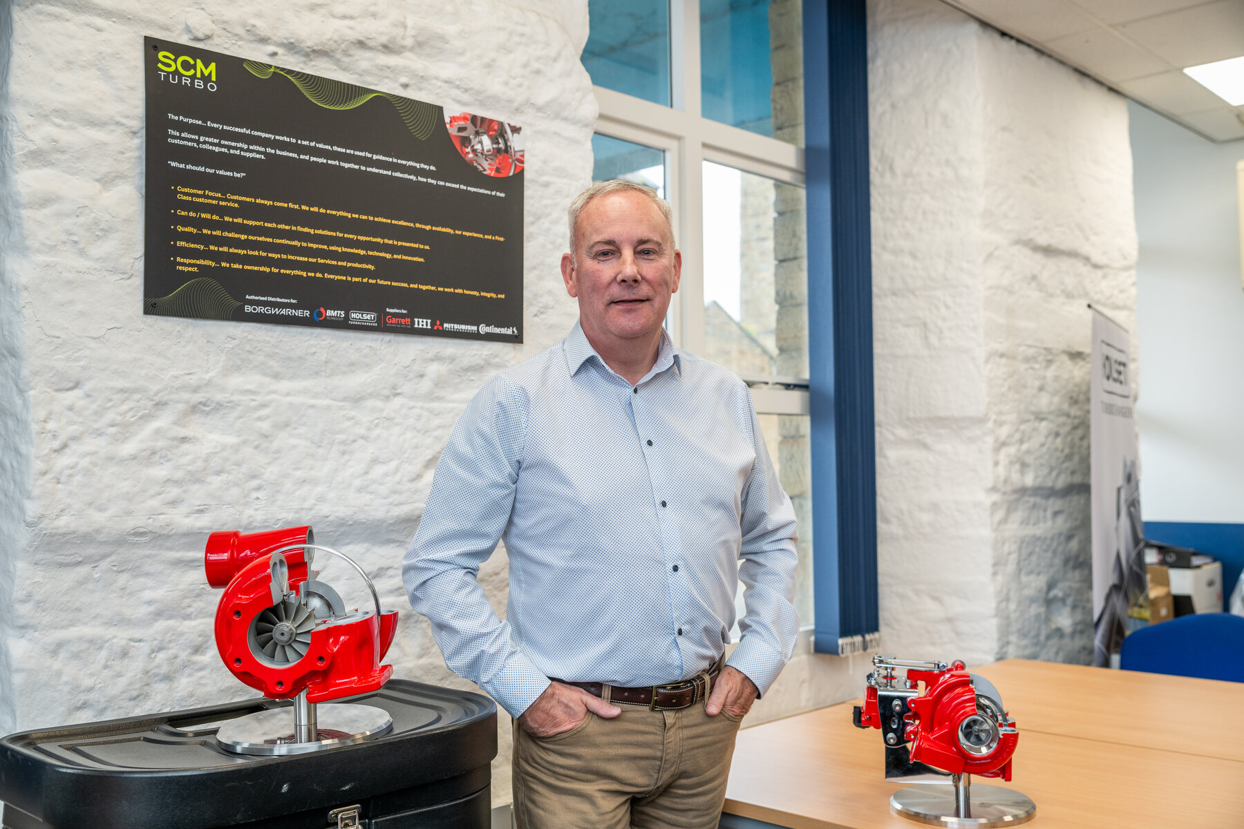 SCM Turbomotive team member with turbochargers at the SCM premises